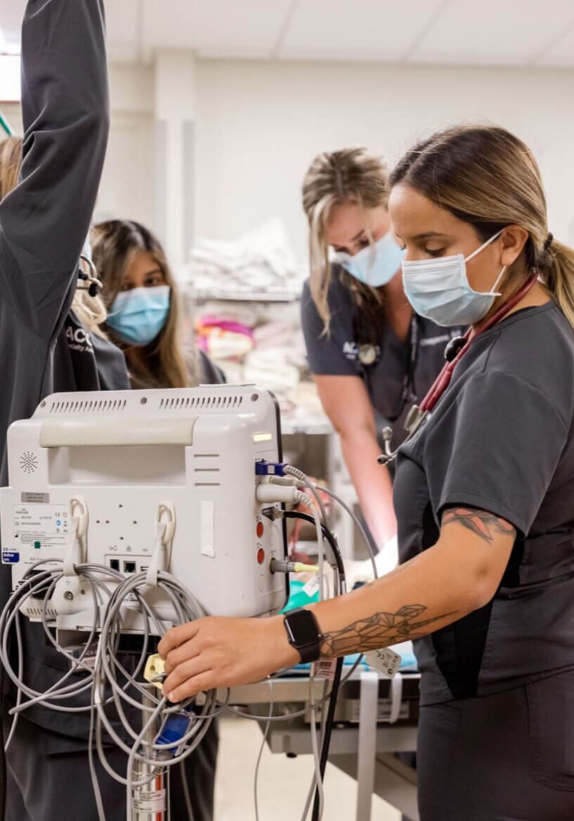 staff adjusting monitoring equipment in ER