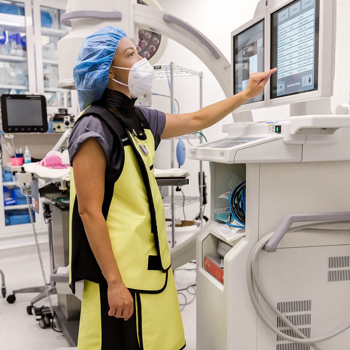 female vet in full scrubs and protective gear performing an advanced veterinary procedure